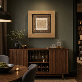 Handmade paper shadow box displayed above a wood console in a warm dining room